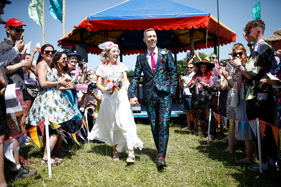 Jack Watney and Sarah Adney celebrate after getting married during Glastonbury Festival at Worthy Farm in 2019.